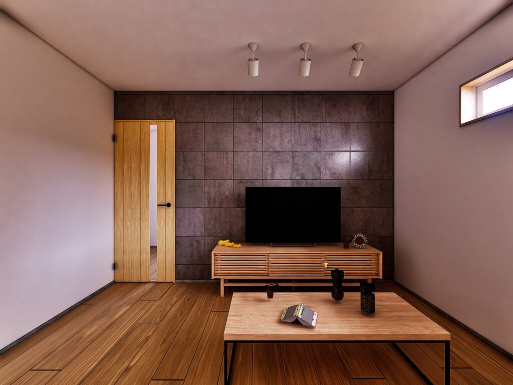 富士市富士見台の中古住宅における壁掛けテレビ対応のダークタイル壁とスポットライト照明。AV機器の配線を隠す壁面補強と防音性を高めた構造で、夜間も落ち着いて過ごせるリビング空間です。